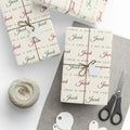 Gifts wrapped in personalized Isaiah 9:6 scripture Christmas paper in ivory with the name Jacob, tied with twine