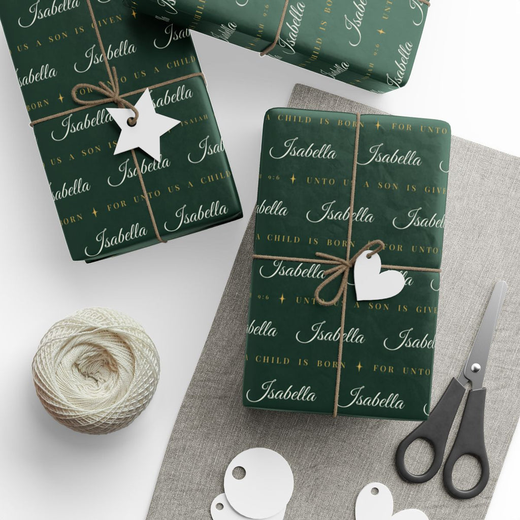 Gifts wrapped in personalized Isaiah 9:6 scripture Christmas paper in evergreen and gold with the name Isabella, tied with twine