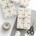 Gifts wrapped in personalized Luke 2:14 scripture Christmas paper in ivory with the name Abigail, tied with twine