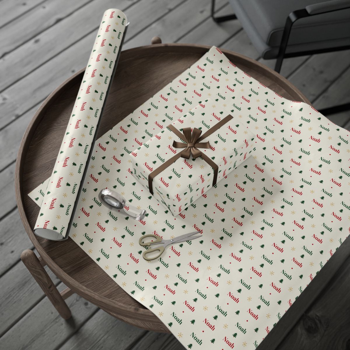 Personalized classic name wrapping paper roll and a wrapped gift on a wooden table