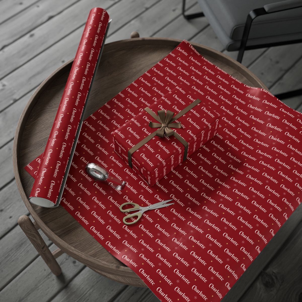 Personalized classic red Christmas paper: the roll and a wrapped gift on a wooden table