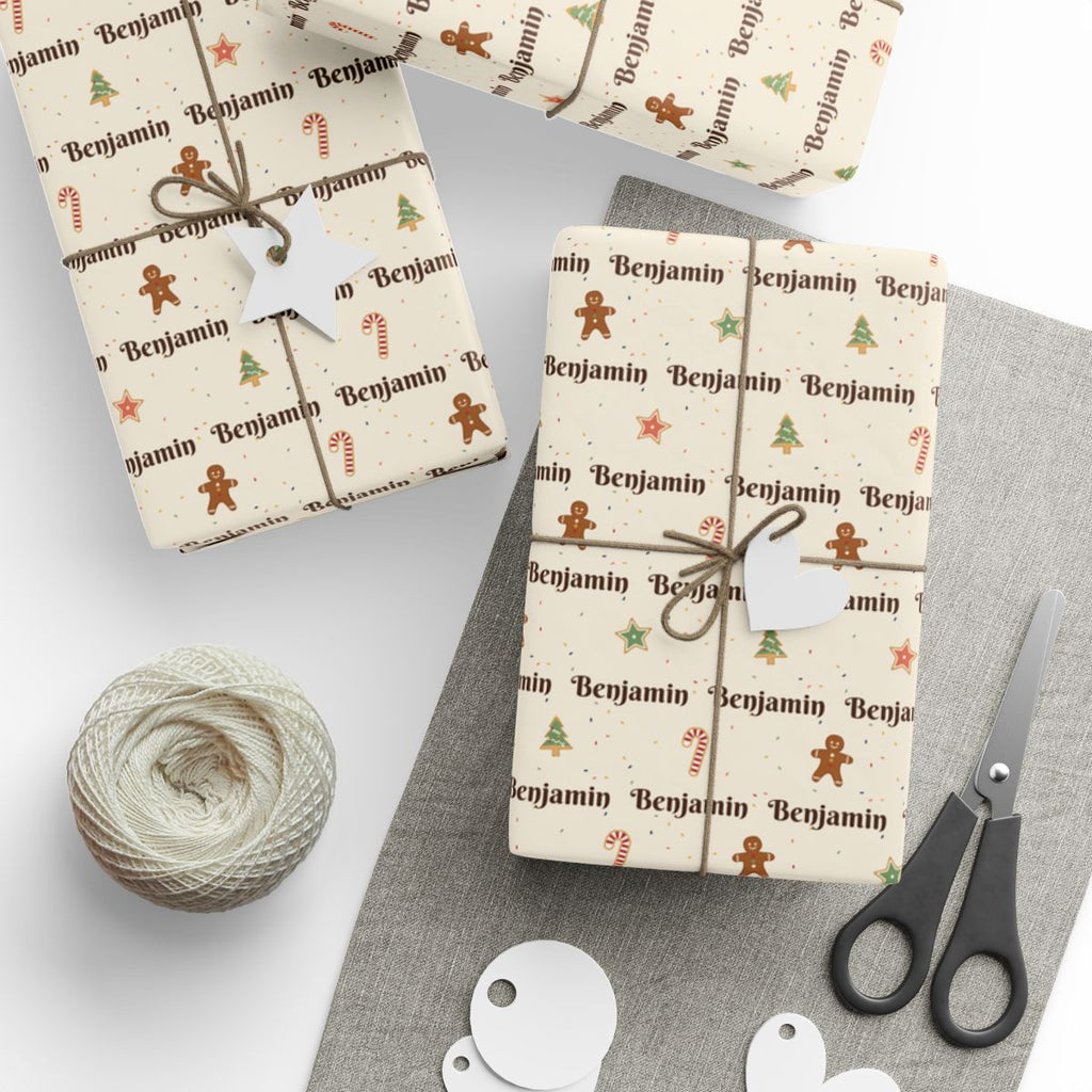 Gifts wrapped in personalized Christmas cookies paper in cream with the name Benjamin, tied with twine