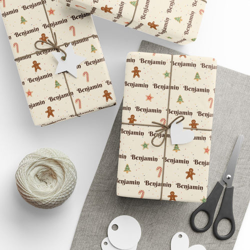 Gifts wrapped in personalized Christmas cookies paper in cream with the name Benjamin, tied with twine