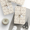 Gifts wrapped in personalized sketched cookies Christmas paper with the name Alexander, tied with twine