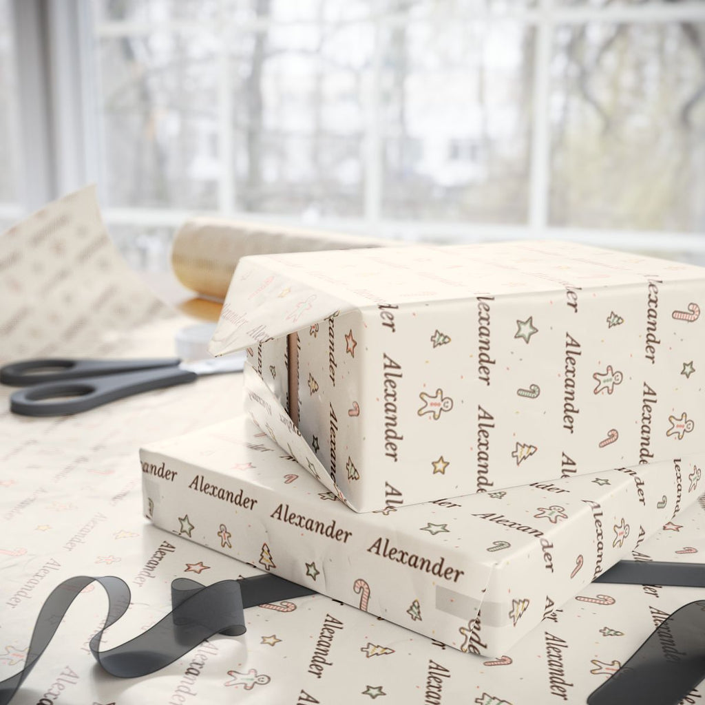 Two gifts wrapped in personalized sketched cookies Christmas paper with the name Alexander, on a table by the window