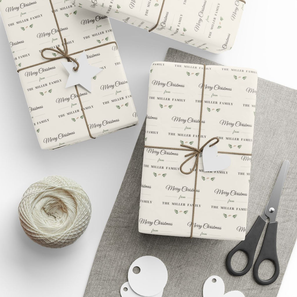 Gifts wrapped in personalized farmhouse Christmas paper reading Merry Christmas from The Miller Family, tied with twine