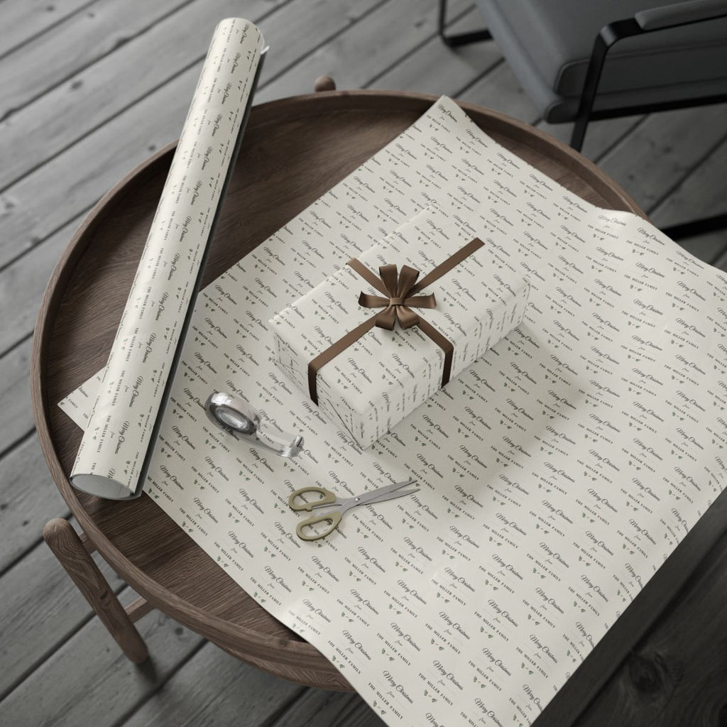 Personalized farmhouse family wrapping paper roll and a wrapped gift on a wooden table