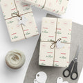 Gifts wrapped in personalized From Santa Christmas paper reading From Santa to Liam, tied with twine