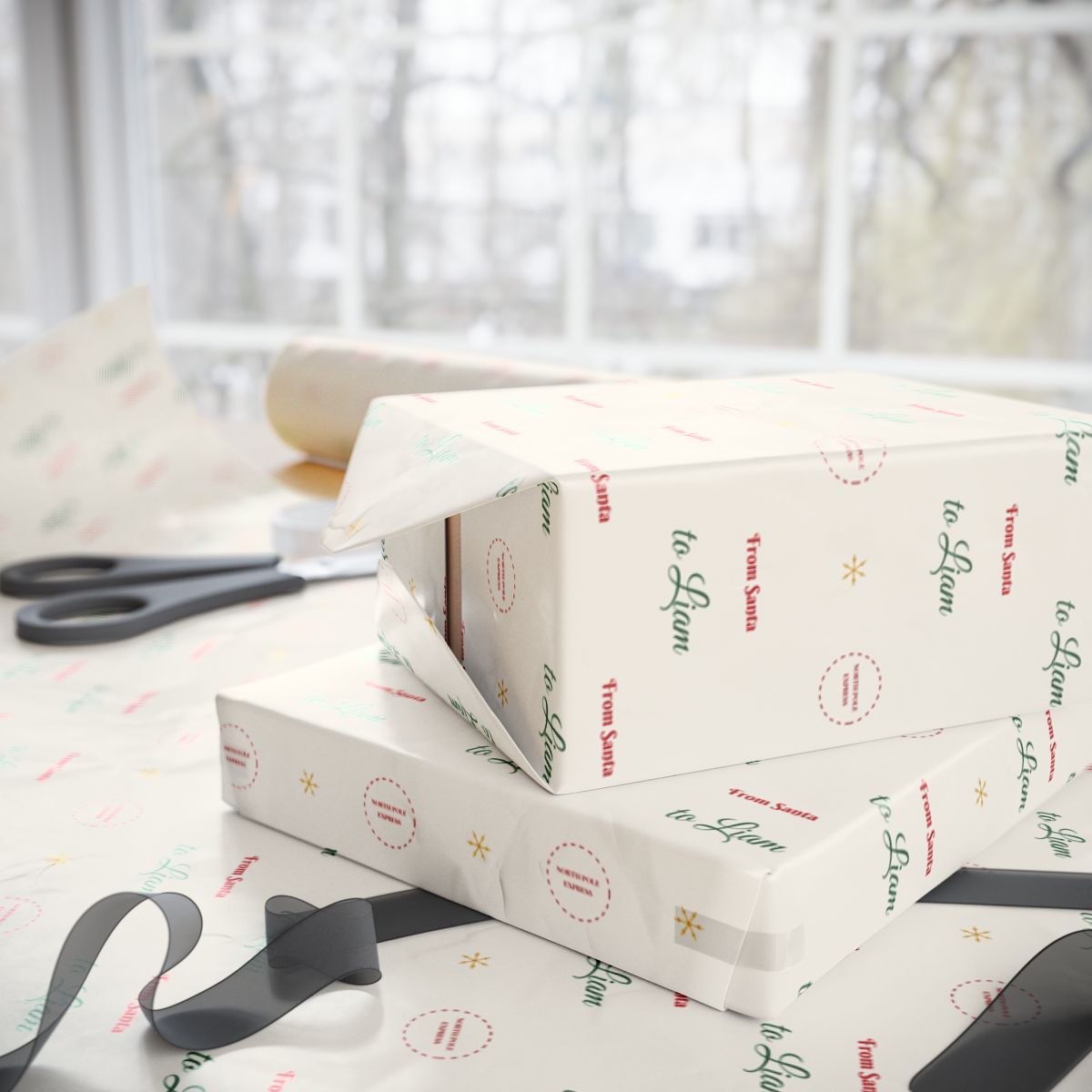 Two gifts wrapped in personalized From Santa Christmas paper reading From Santa to Liam, on a table by the window