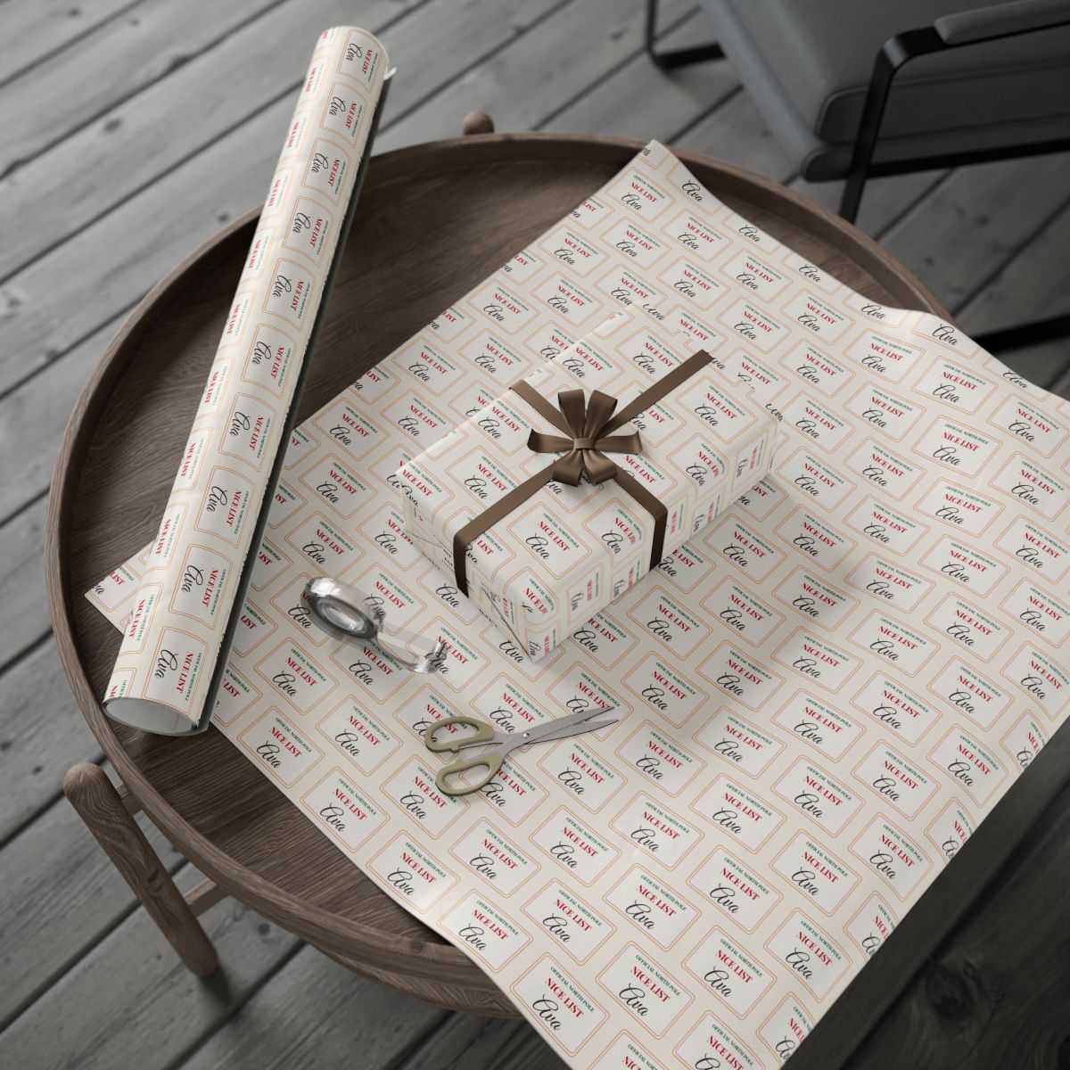 Personalized Nice List wrapping paper roll and a wrapped gift on a wooden table