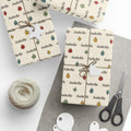 Gifts wrapped in personalized hand-drawn ornaments Christmas paper with the name Isabella, tied with twine
