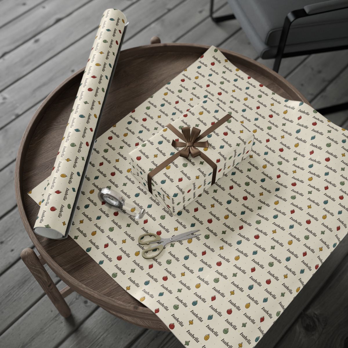 Personalized hand-drawn ornaments Christmas paper: the roll and a wrapped gift on a wooden table