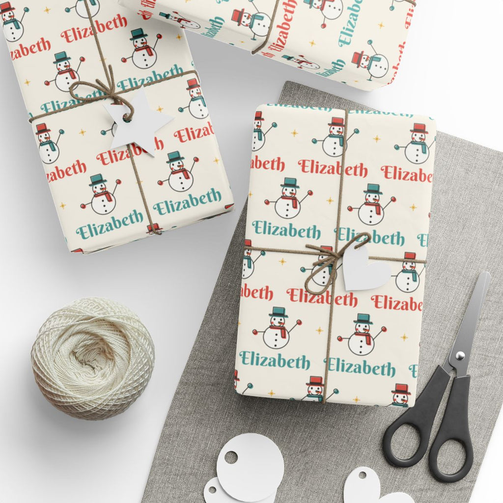 Gifts wrapped in personalized retro snowman Christmas paper with the name Elizabeth, tied with twine