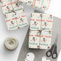 Gifts wrapped in personalized retro snowman Christmas paper with the name Elizabeth, tied with twine