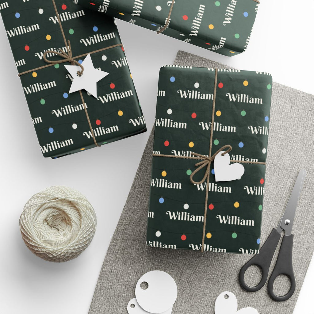 Gifts wrapped in personalized string lights Christmas paper with the name William, tied with twine